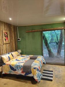 a bedroom with a bed and a green wall at Vulture's View 7 in Pretoria