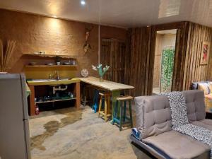 a kitchen with a table and a chair and a sink at Vulture's View 7 in Pretoria