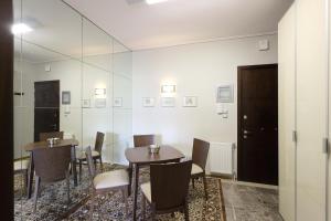a room with two tables and chairs and a mirror at GKs Park View in Ioannina