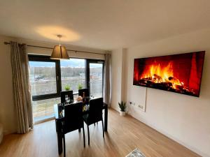 a living room with a fireplace on the wall at Empire Serviced Apartments in Leicester