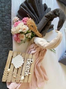 a bunch of towels and flowers on a table at Villa Sun&Sea in Komarna