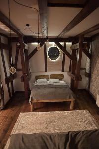 a bedroom with a bed in a room with wooden beams at Apartament na Piernikarskiej in Toruń