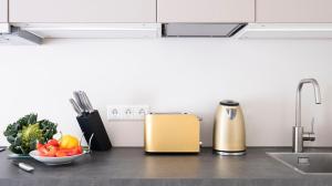 a kitchen counter with a yellow refrigerator and a bowl of vegetables at Central and new designer flat - Yael's apartments - Charlottenburg by Arbio in Berlin