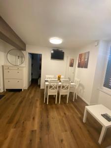 a kitchen and dining room with a table and chairs at Jolly -Center Bright Apartment at Tartini Square in Piran
