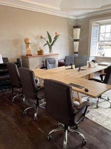 a conference room with a large wooden table and chairs at Gato Azul - Coliving in La Orotava +31 photos