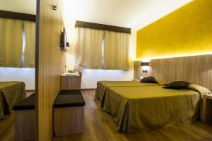 Postel nebo postele na pokoji v ubytování Sangallo Park Hotel