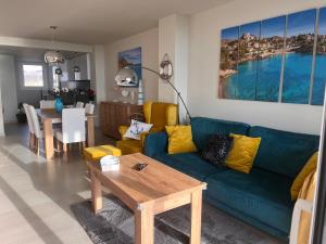 a living room with a blue couch and a table at Sol y Mar in El Campello