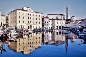 a view of a city with boats in the water at Jolly -Center Bright Apartment at Tartini Square in Piran