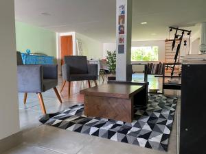 a living room with a coffee table on a checkered floor at Pousada Videira de Teresópolis in Teresópolis