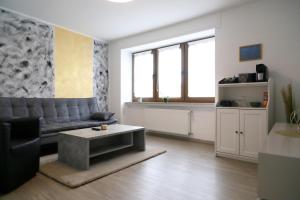 a living room with a couch and a coffee table at Pension am Treiser Kiosk in Treis-Karden