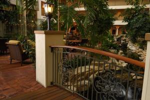 a balcony with a wrought iron railing in a restaurant at Woolley's Classic Suites Denver Airport in Aurora