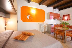 a room with a table and a kitchen with a dining room at Residenza Pesce D'Oro in Verbania