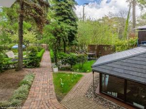 a brick path in a garden with a house at Pensjonat Przedwiośnie in Jurata +33 photos
