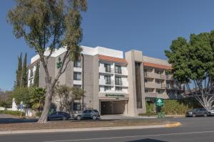 an apartment building with cars parked in front of it at GreenTree Inn & Suites Los Angeles - Alhambra - Pasadena in Alhambra