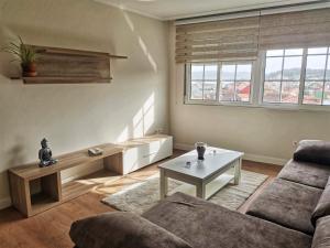 a living room with a couch and a table at APTO. SANXURXO in Camariñas