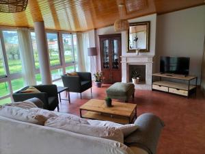 a living room with a couch and a fireplace at Casa das Mareas in Muros