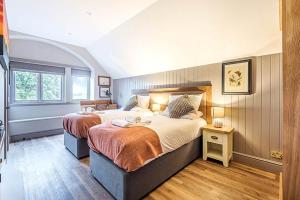 a large bedroom with two beds and a window at Charlcombe Inn in Bath
