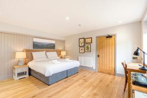 a bedroom with a large bed and a desk at Charlcombe Inn in Bath