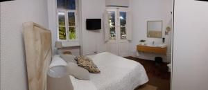 a small room with a bed and a bathroom at WW Hostel & Suites in Coimbra
