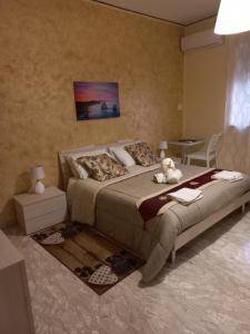 a bedroom with a bed with a teddy bear on it at acqua di mare in Taranto