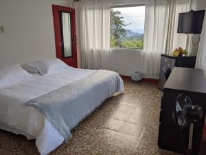 Voodi või voodid majutusasutuse Hacienda Guayabal toas