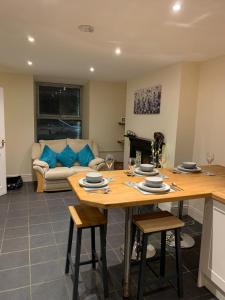 a living room with a table and a couch at Cosy cottage in picturesque Snowdonia with stunning views of the Moelwyn mountains in Blaenau-Ffestiniog