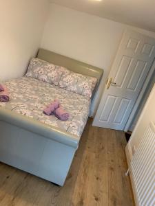 a small bedroom with a bed with a teddy bear on it at Cosy cottage in picturesque Snowdonia with stunning views of the Moelwyn mountains in Blaenau-Ffestiniog