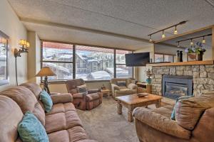 a living room with a couch and a fireplace at Copper Mountain Condo Walk to American Eagle Lift in Copper Mountain