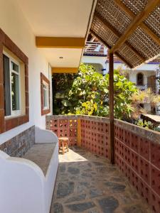 an outdoor patio with a bench and a fence at Casa Terranova in Puerto Escondido