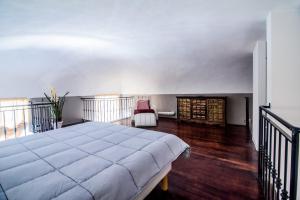 a bedroom with a large bed and a balcony at Pretty home in Sanremo