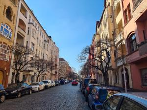 a street with cars parked on the side of the road at Arbio I Stylish Apart Schöneberg S-Bahn in Berlin