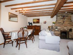 uma sala de estar com uma mesa e uma lareira em 4 Mowhay Cottages em Saint Goran