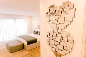 a bedroom with a wall made out of books at DCM LOFTS in Arcozelo