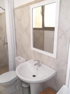 a bathroom with a sink and a toilet and a mirror at Can Tianyico in Sa Pobla +2 photos