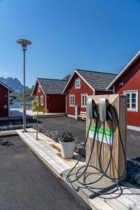 a pair of phone chargers in front of a red building at Lofoten Cabins - Kåkern in Ramberg