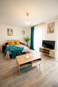 a living room with a bed and a coffee table at Le Délicieux T2-42m2-Disney in Montévrain