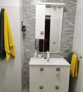 a bathroom with a white sink and a mirror at Luxury Vista mar y playa Torres del Sol B404 in Playa de las Americas