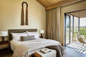 a bedroom with a bed and a sliding glass door at Stanly Ranch, Auberge Resorts Collection in Napa
