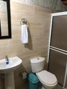 a bathroom with a white toilet and a sink at Hotel Boutique Casa Antigua in San Vicente de Chucurí