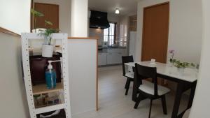 a kitchen and dining room with a table and chairs at Guest House Mulberry - Vacation STAY 9580 in Kirishima