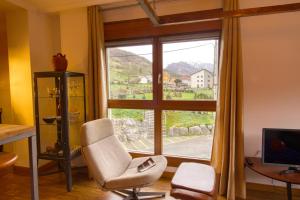 a living room with a chair and a window at Loft Felechosa in Felechosa