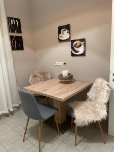 a dining room table with two chairs and a table with cups and plates at Apartment zur Wiege Anhalts in Ballenstedt