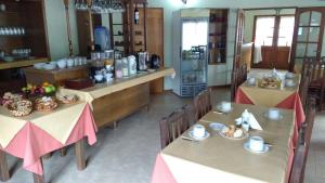 a restaurant with two tables and chairs with food on them at DEL INFINITO in Capilla del Monte