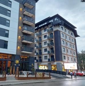 a tall building with a sign on the side of it at Apartmani Montis Zlatibor in Zlatibor