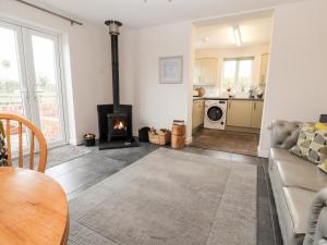 a living room with a couch and a fireplace at The Old Stable in Penyffordd