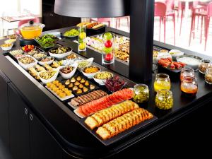 a buffet with many different types of food on at Campanile Montluçon ~ Saint-Victor in Saint-Victor