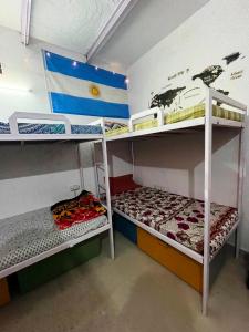 a room with two bunk beds and a flag at Zigzag Homestay in Agra