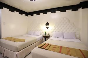 Postel nebo postele na pokoji v ubytování Camelot Hotel Quezon City powered by Cocotel