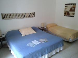 a room with two beds in a room at El Refugio de Coquena in Purmamarca +59 photos