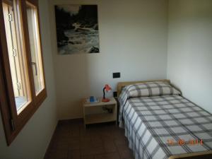 a small bedroom with a bed and a window at Castello San Romano in Baiso